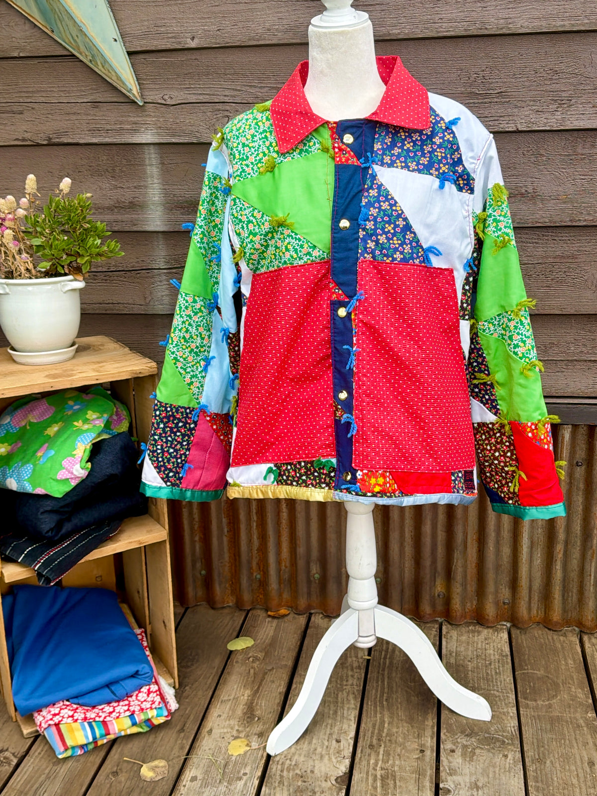 Close-up of the large red pockets on the vintage patchwork quilt camp coat with red collar