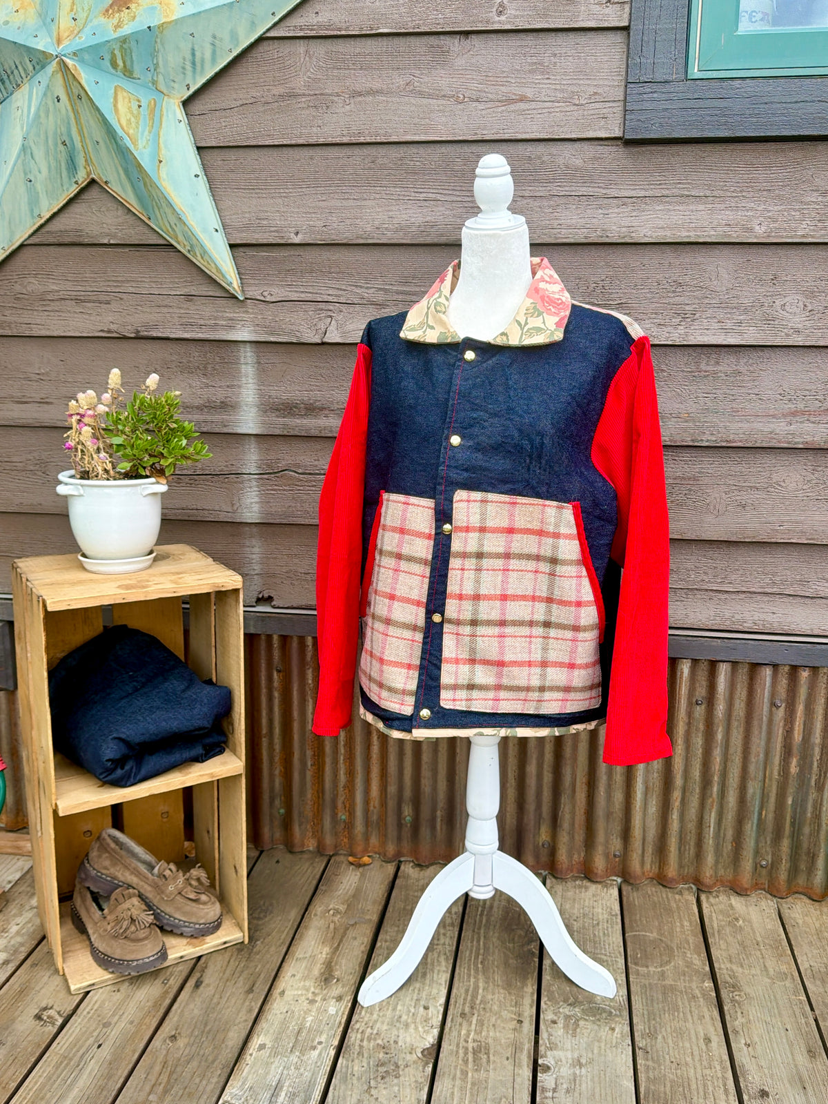 Denim barn coat with red corduroy sleeves on a mannequin, front view