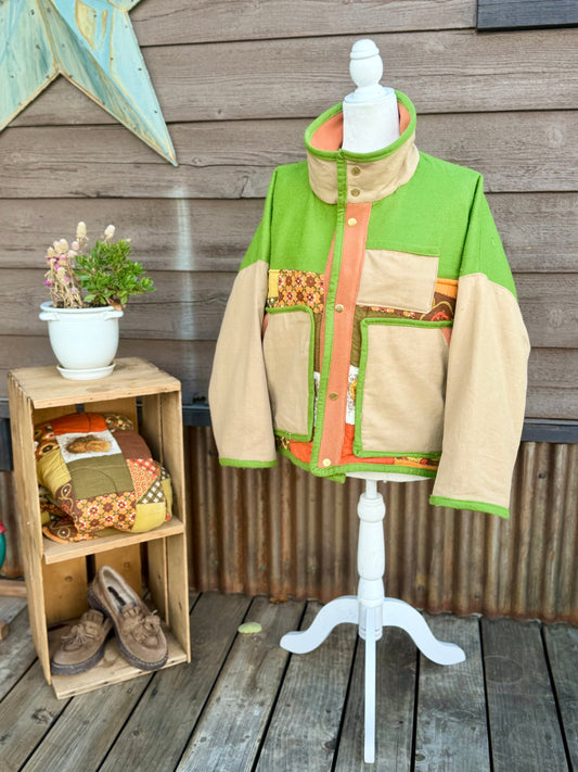 Green and tan sleeping bag boxy chore coat on a mannequin, front view