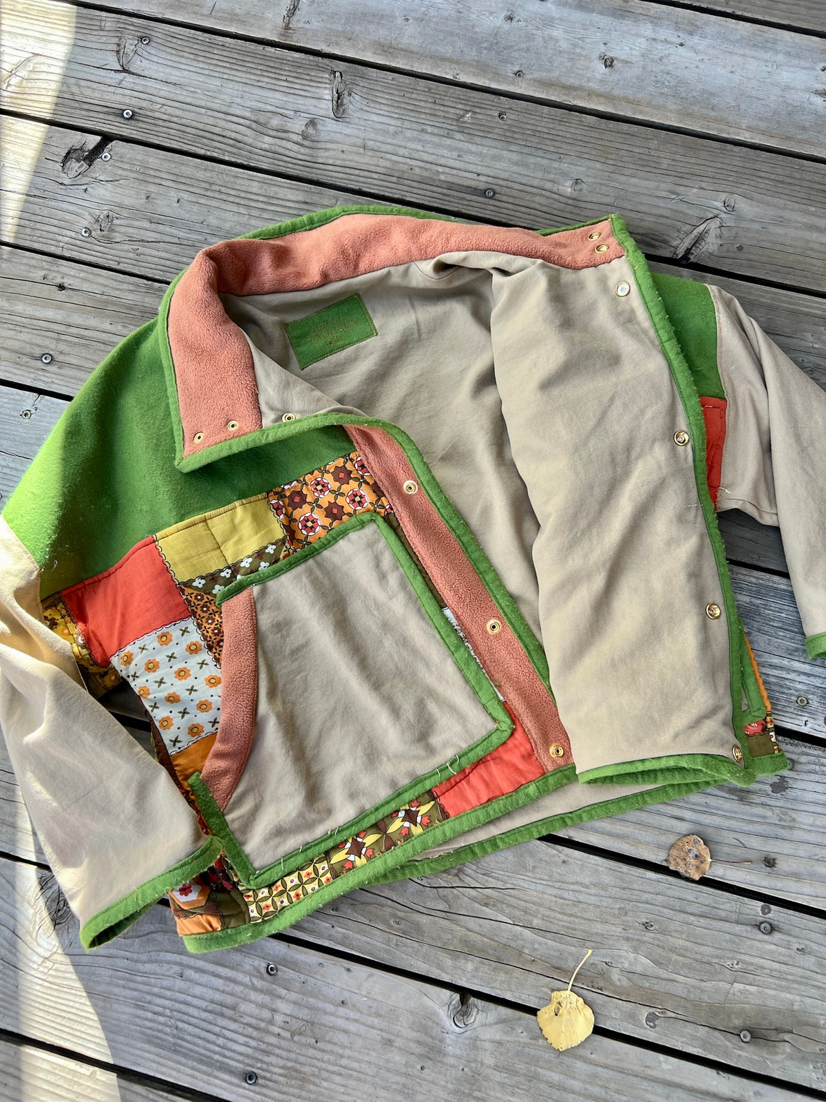 Inside of the green and tan sleeping bag boxy chore coat showing the soft cotton canvas lining