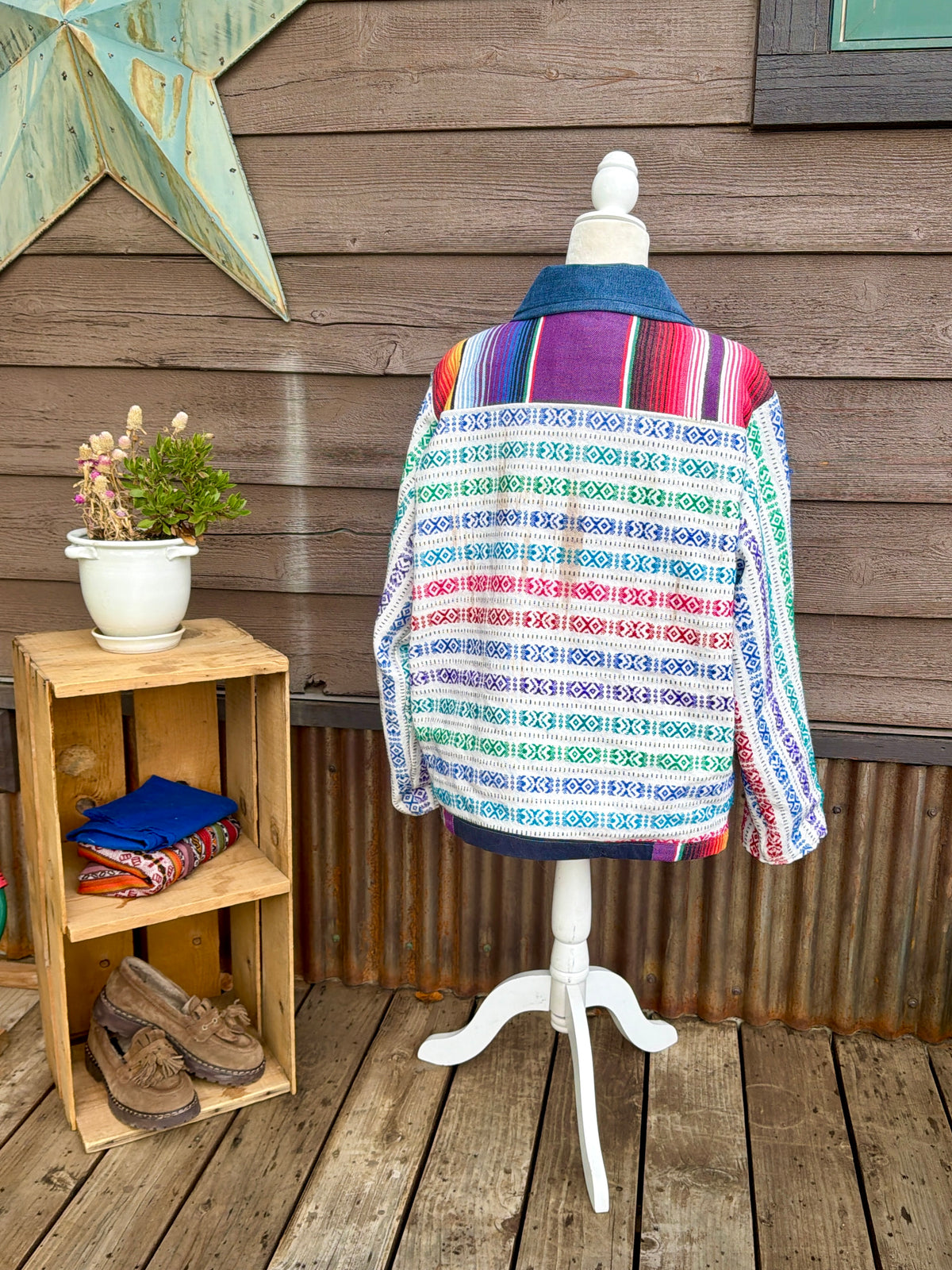 Back of the multicolor woven stripe blanket camp coat on a mannequin showing the woven stripe blanket back
