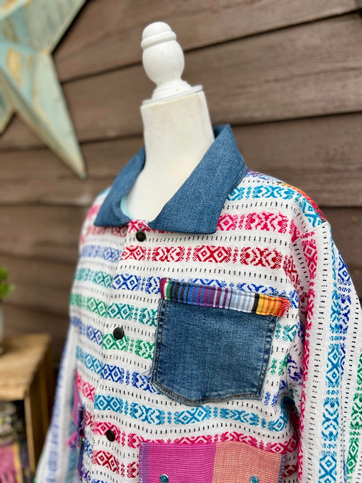 Multicolor woven stripe blanket camp coat on a mannequin, front panel view