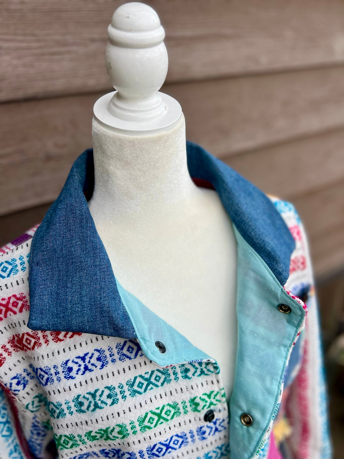 Close-up of the collar and inside lining of striped woven camp coat