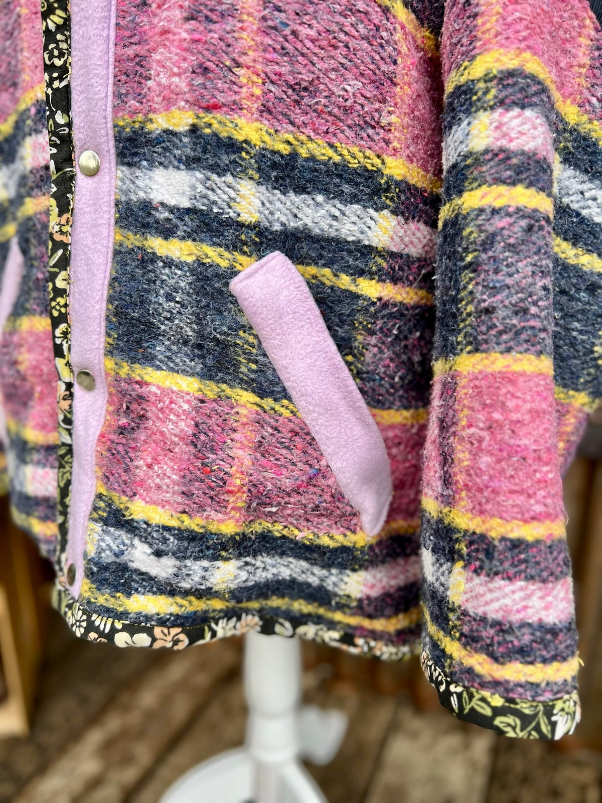Close-up of the lilac fleece pocket flaps and snap placket on the pink plaid wool blanket boxy chore coat
