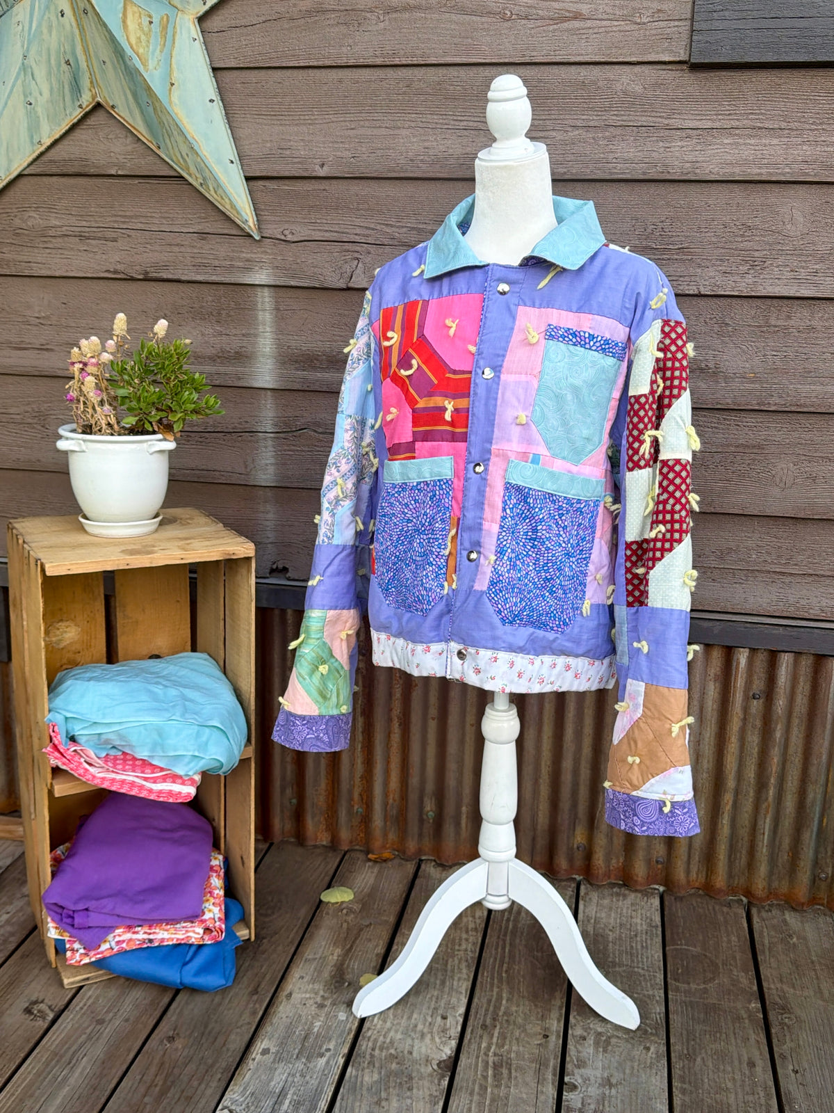 Purple patchwork vintage quilt camp coat on a mannequin, front view