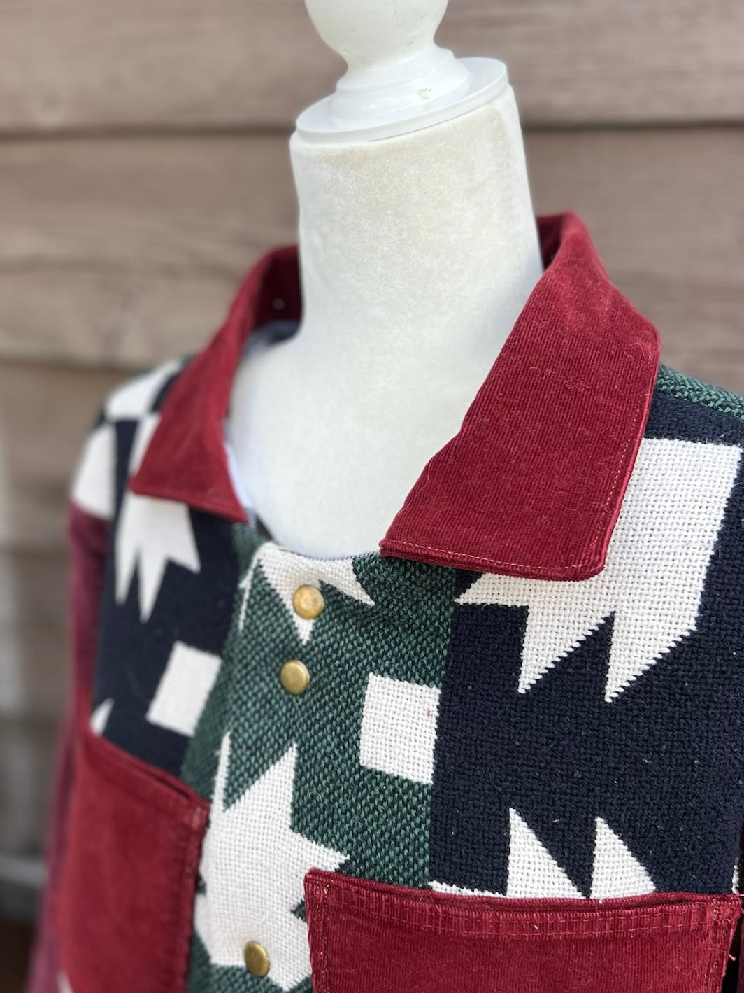 Close-up of the burgundy corduroy collar and snaps on the Southwestern blanket camp coat with burgundy corduroy