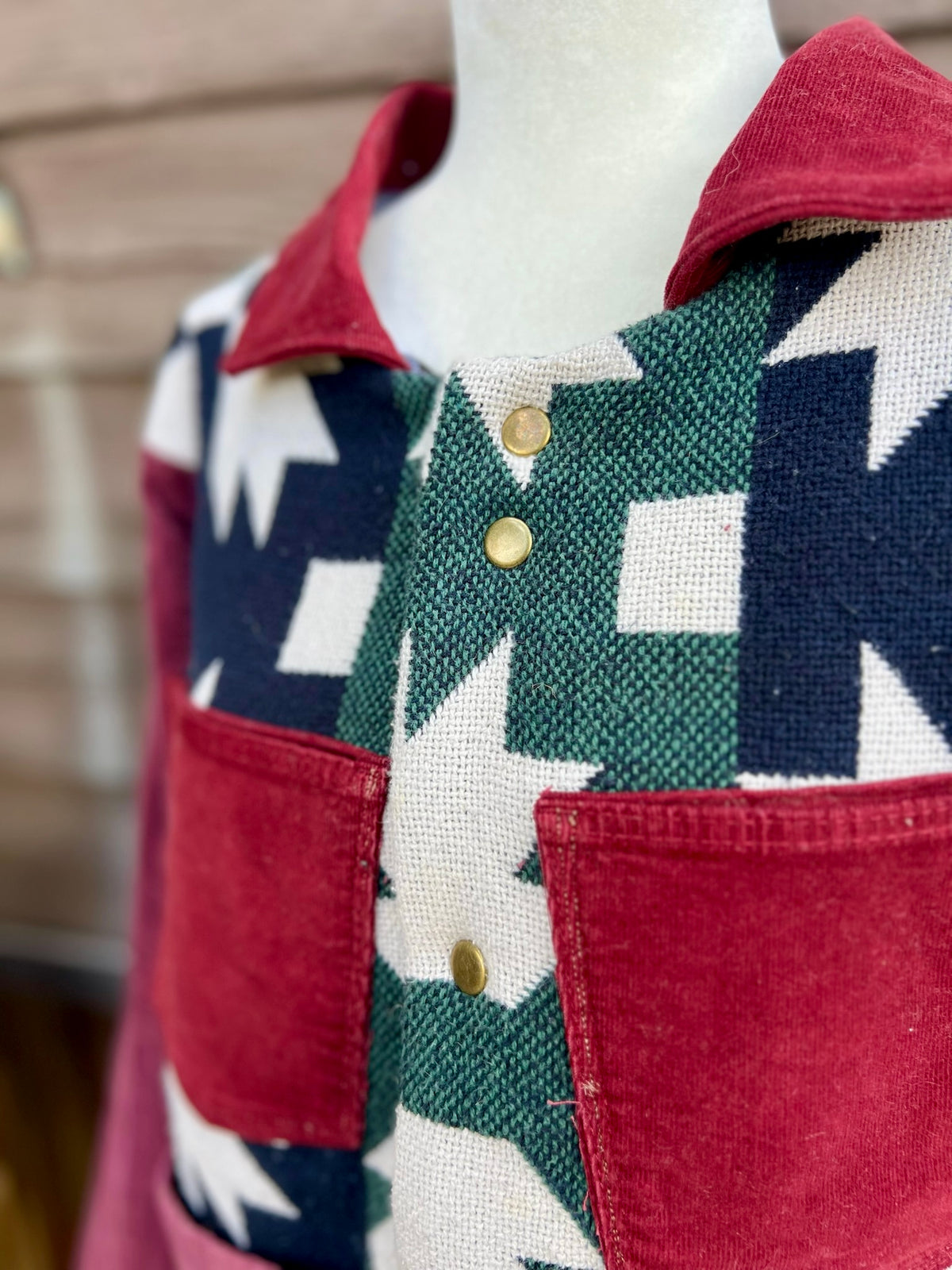 Close-up of the burgundy corduroy chest snap closure and pockets