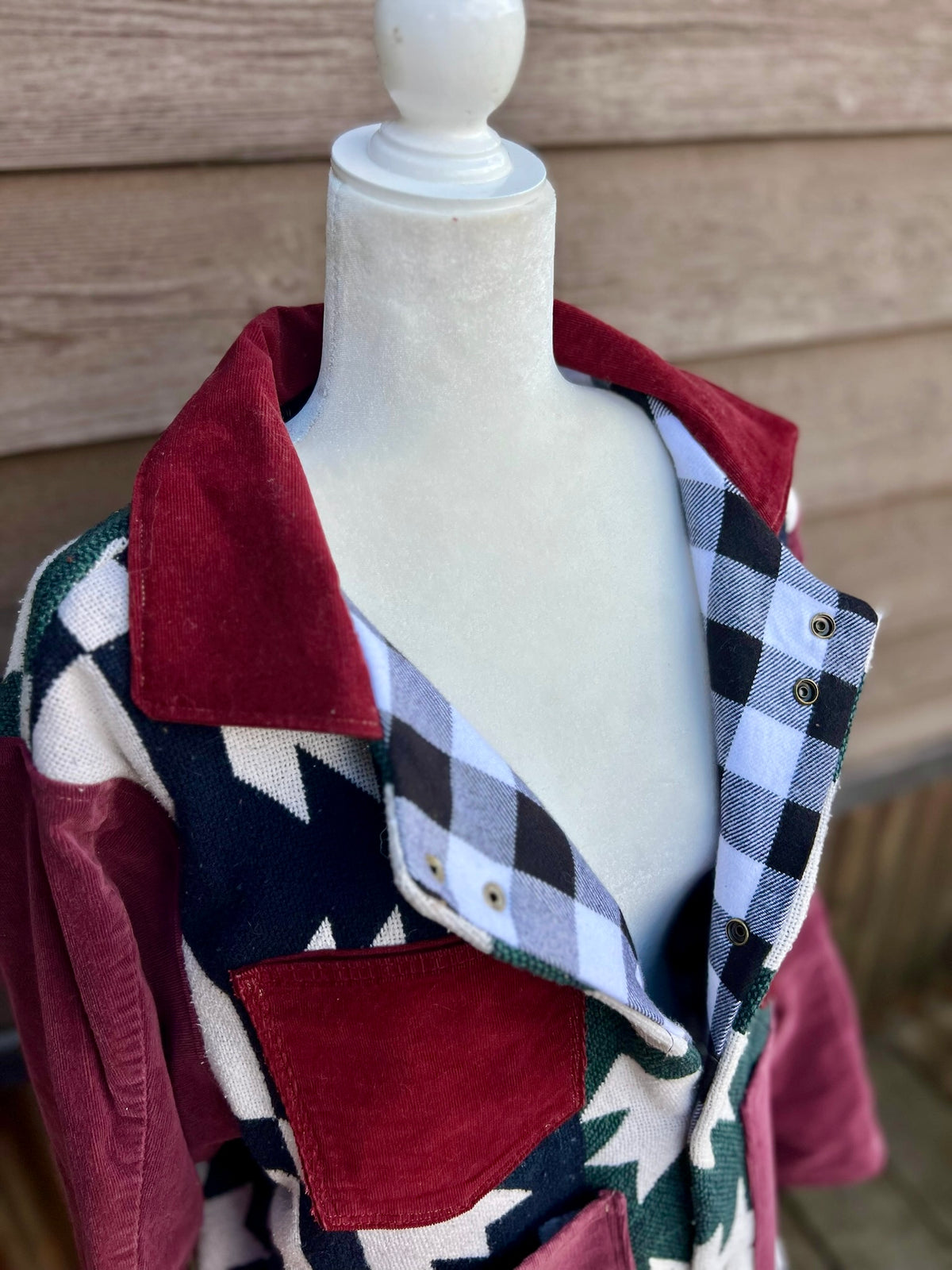 Front closure and inside of the Southwestern blanket camp coat showing the black and white plaid flannel lining