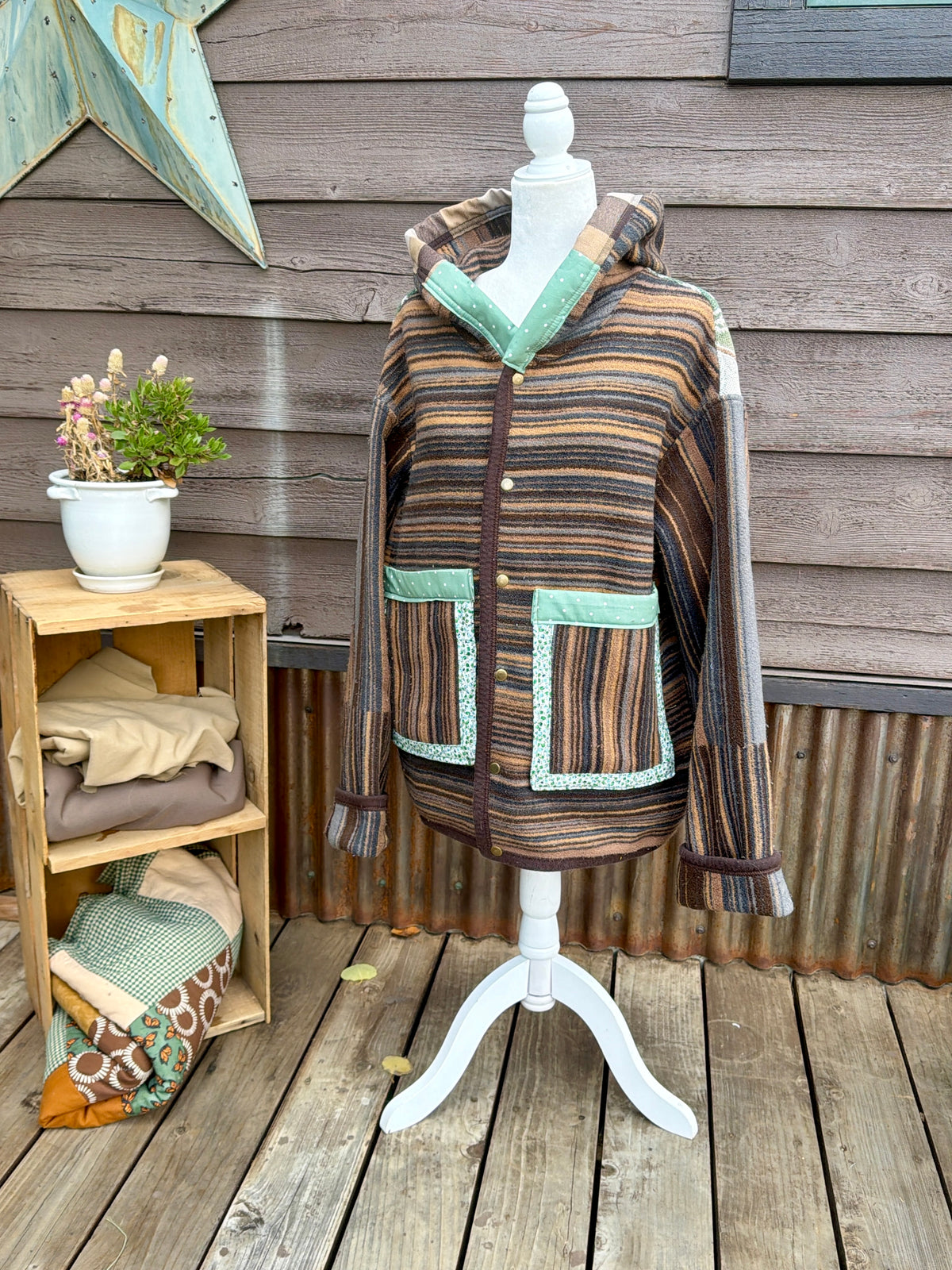 Striped horse blanket hooded coat on a mannequin, front view