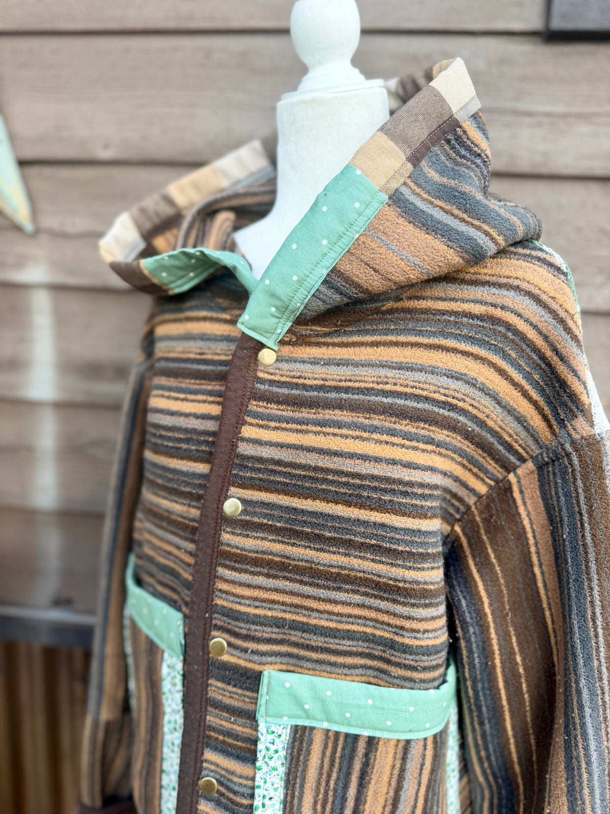 Close-up of the hood and snap front on the striped horse blanket hooded coat