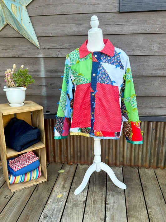 Vintage patchwork quilt camp coat with red collar on a mannequin, front view