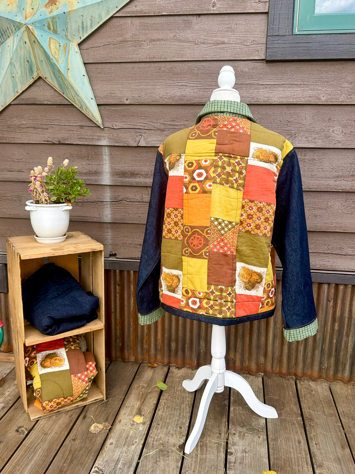 Back of the sleeping bag camp coat on a mannequin showing the quilted sleeping bag back and denim sleeves