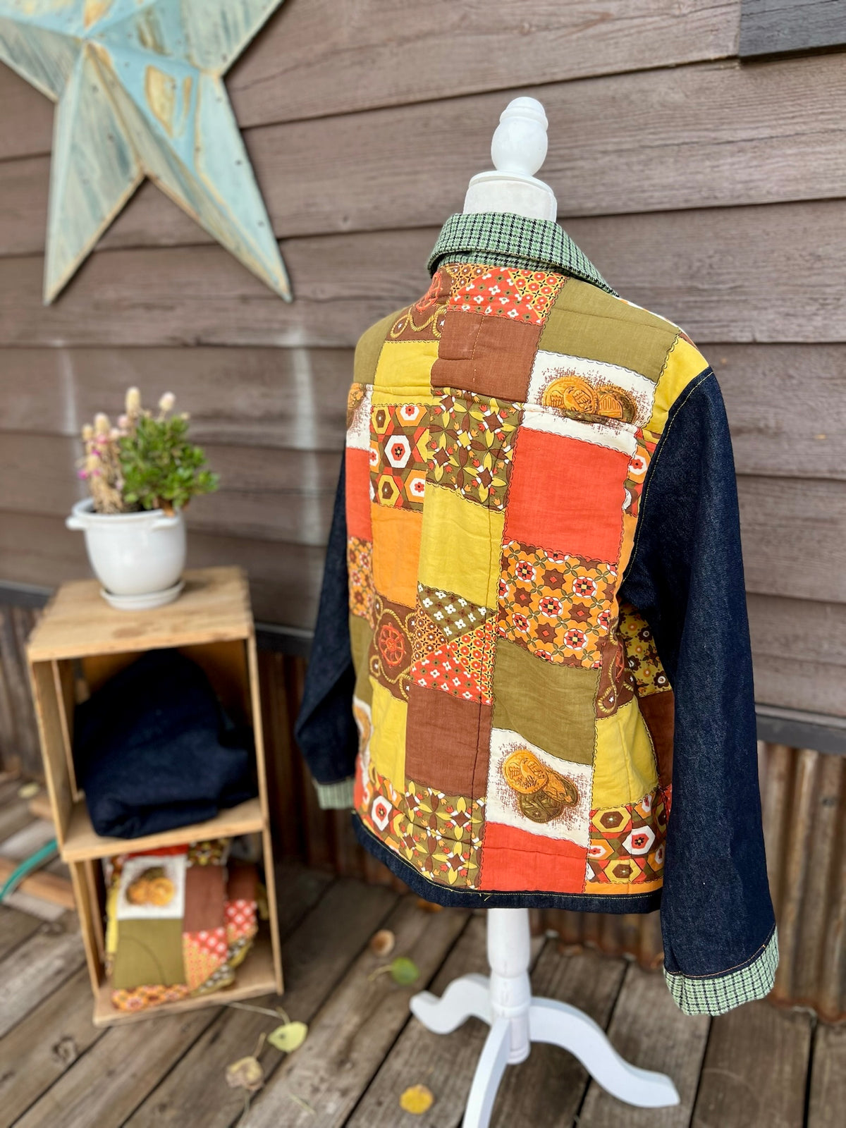 Vintage sleeping bag camp coat in yellow, brown and orange on a mannequin, back side view