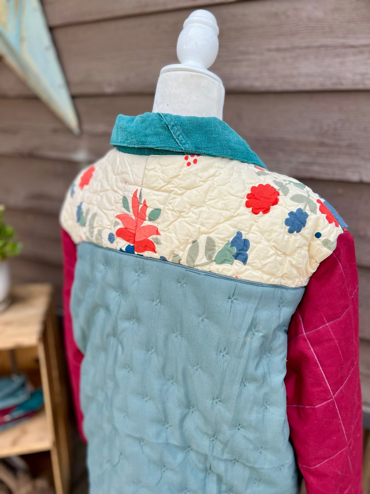 Back yoke of the yellow quilt camp coat with denim sleeves on a mannequin showing the yellow quilted back and denim sleeves