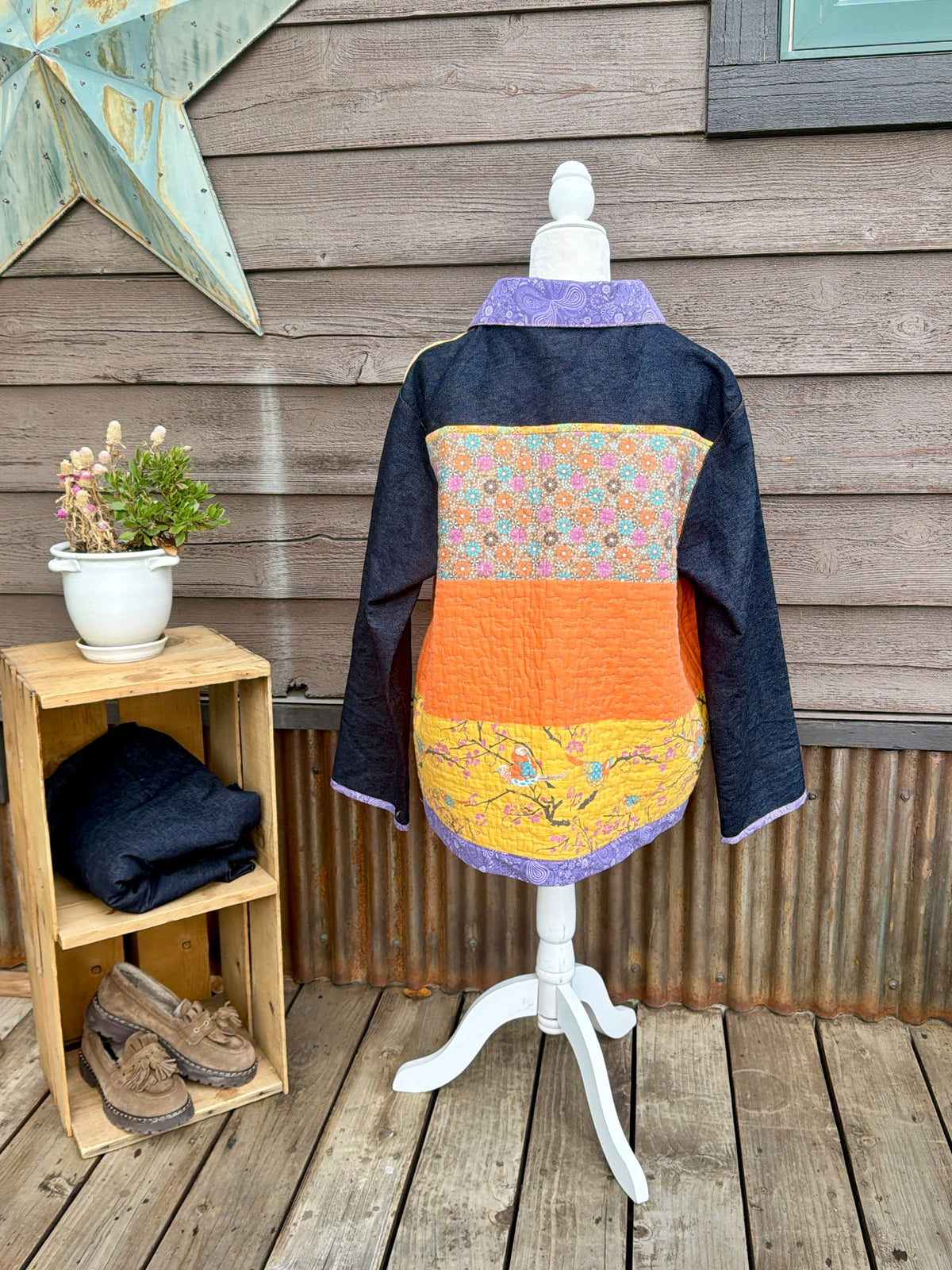 Back of the yellow quilt camp coat with denim sleeves on a mannequin showing the yellow quilted back and denim sleeves