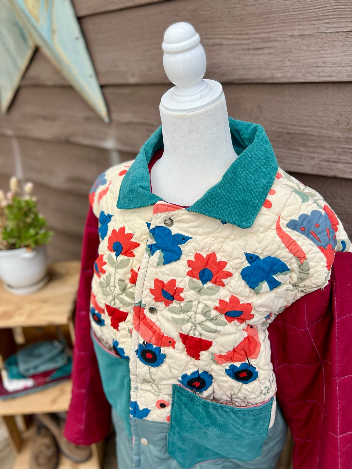 Close-up of the purple collar and snap placket on the yellow quilt camp coat with denim sleeves